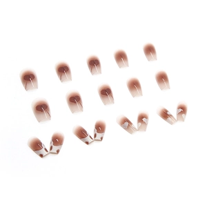 Caramel amber ombre press-on nails with sweet heart patterns and white irregular accents
