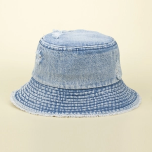 Distressed denim sun hat with frayed edges and vintage ripped details in light blue color