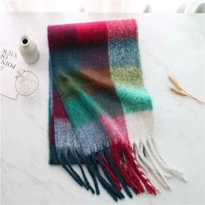 Detailed view of colorful checkered plaid scarf with thick tassels and soft wool texture