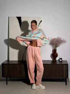 Chic knitwear set with pink and blue contrast floral sweater and matching pink trousers