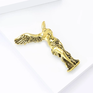 Golden Winged Victory Goddess brooch presented on a white geometric display stand