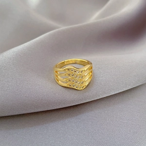 Adjustable gold wave ring with four rows of sparkling white zircons on silk background