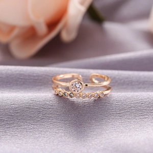 Detailed macro view of gold-plated double-layered adjustable ring with zircon setting