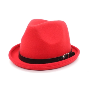 Detail of red wool fedora hat featuring a black leather band and silver metal buckle