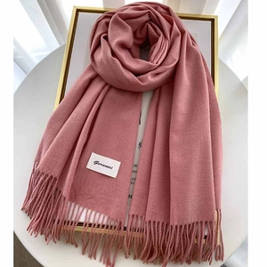 Macro detail of soft pink cashmere scarf showing fine texture and fringed edges