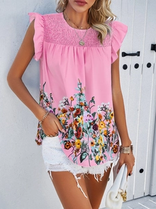 Detail of pink floral sleeveless top featuring ruffled shoulders and smocked chest bodice