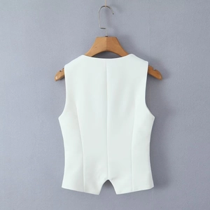 Detailed view of a white tailored sleeveless vest hanging on a wooden hanger