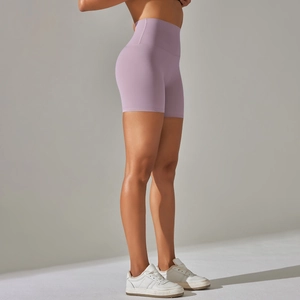 Macro view of purple high-waisted seamless yoga shorts with peach butt lift sculpting