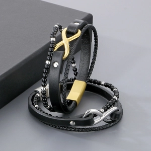 Close-up of multilayer leather bracelets with gold and silver infinity symbols and beads
