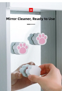 Cat paw shaped cleaning sponge attached to bathroom mirror for easy stain removal