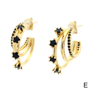 Close-up of golden multi-layered C-shape hoop earrings with black zircon stone inlay
