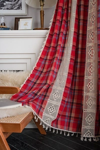 Detail of red Christmas plaid curtain with beige lace trim and tassel edge on chair