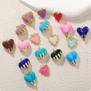 Detailed view of colorful heart charms with gold loops and vibrant enamel filling