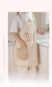 Close-up of waterproof kitchen apron showing rabbit print and absorbent hand towels
