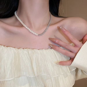 Elegant gold plated necklace featuring white pearls and shimmering cubic zirconia chain