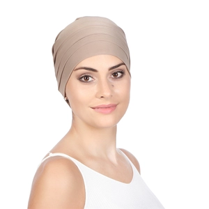Detail showing the pleated texture and khaki stretch fabric of the women turban hat