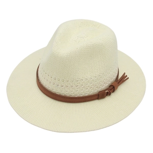 Detail of cream woven straw fedora featuring a brown leather band and gold buckle