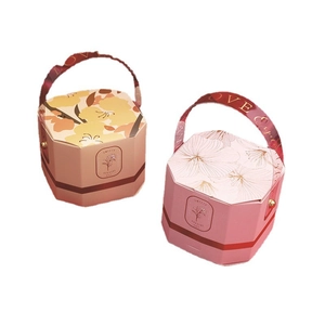 Pink and apricot hexagonal wedding candy gift boxes with elegant carry straps and gold rivets