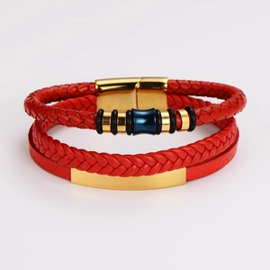 Detail of red multilayer woven leather bracelet with golden magnetic clasp and blue accents