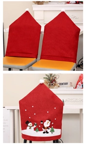 Detail of red Santa hat chair covers and festive snowman prints for Christmas decor