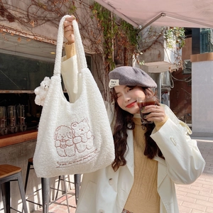 White plush tote bag with cute bear embroidery and teddy charm in a sunny cafe setting