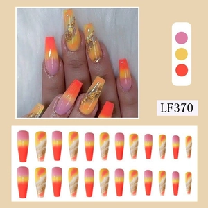Long almond press-on nails with orange pink gradient and gold glitter textures