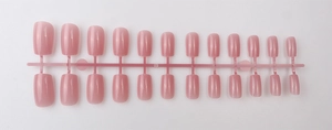 Detail of 24 pieces long square press-on nails in nude pink finish on plastic rack