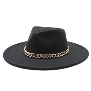 Detailed view of black wool fedora featuring a bold gold metal chain band decoration