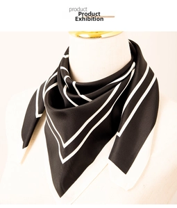 Detail of a chic black and white square silk scarf with geometric border patterns
