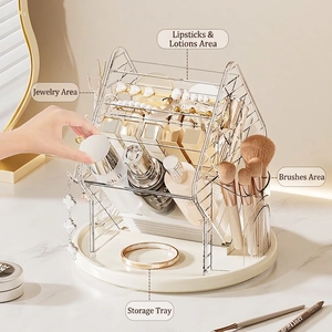 Rotatable makeup organizer with jewelry hooks and brush holder on marble desk