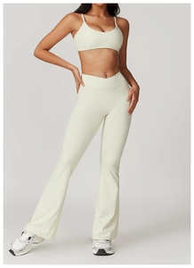 Front view of cream yoga set with strappy sports bra and flared high-waist pants