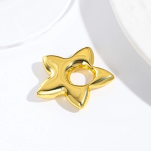 Detailed view of hollow five-pointed star metal charm in shiny gold finish for DIY jewelry