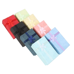 Colorful rectangular jewelry gift boxes with elegant ribbon bows for rings and necklaces