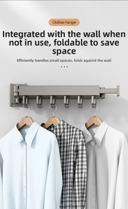 Detail of wall-mounted folding clothes rack in matte grey finish with multiple hooks