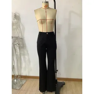 Détail du pantalon évasé noir taille haute montrant le bouton et les poches plates