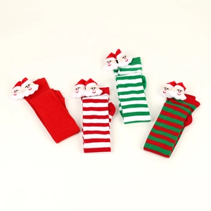 Detail of colorful Christmas thigh high stockings with plush Santa Claus doll decoration