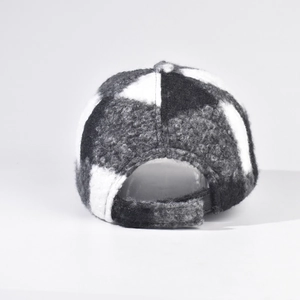 Macro shot of plaid bouclé baseball cap with adjustable velcro strap on the back
