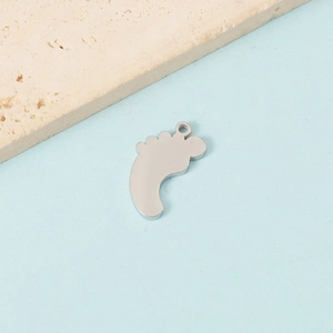 Detailed view of mirror-finish baby feet charm for DIY personalized jewelry making