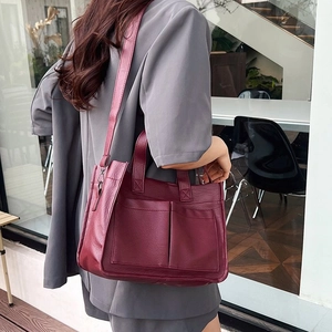 Detail of burgundy PU leather tote bag with large capacity and double exterior pockets