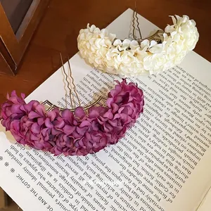 Elegant fabric flower hair pins in purple and cream silk on a vintage book