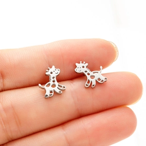 Close-up of minimalist stainless steel giraffe stud earrings held by hand to show size