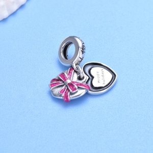 Sterling silver double heart charm with pink enamel bow and Happy Holidays engraving