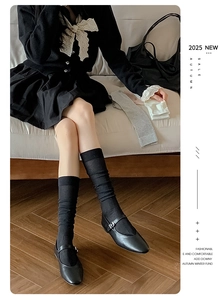 Close-up of black ribbed mid-calf socks with Mary Janes for a vintage preppy aesthetic