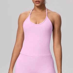 Detail of pink halter yoga top and leggings with cross-strap back and seamless texture
