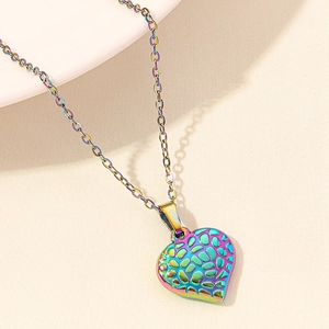 Detailed macro view of heart-shaped iridescent 18k gold plated stainless steel pendant