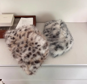 Detailed plush texture of brown and grey leopard print faux fur winter bucket hats
