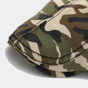 Close-up of camouflage cap brim with reinforced black double-stitch sewing on canvas fabric