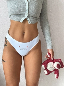 Detail showing white ice silk thong with cute cat ear print and smooth seamless texture