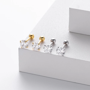 Macro view of gold and silver S925 sterling silver screw back earrings with 4-claw cubic zirconia