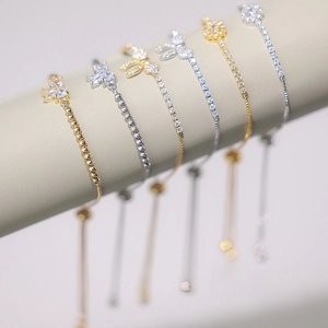 Detail of elegant butterfly bracelets with micro-paved zircons and adjustable pull strings